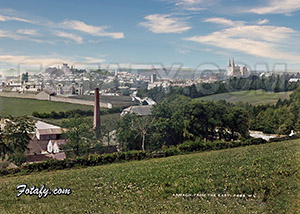 This is an early 1900s photo of Armagh shot from the eastern outskirts of the city during a sunny day. The spires and towers of four of the city's churches and cathedrals can be seen in the distance